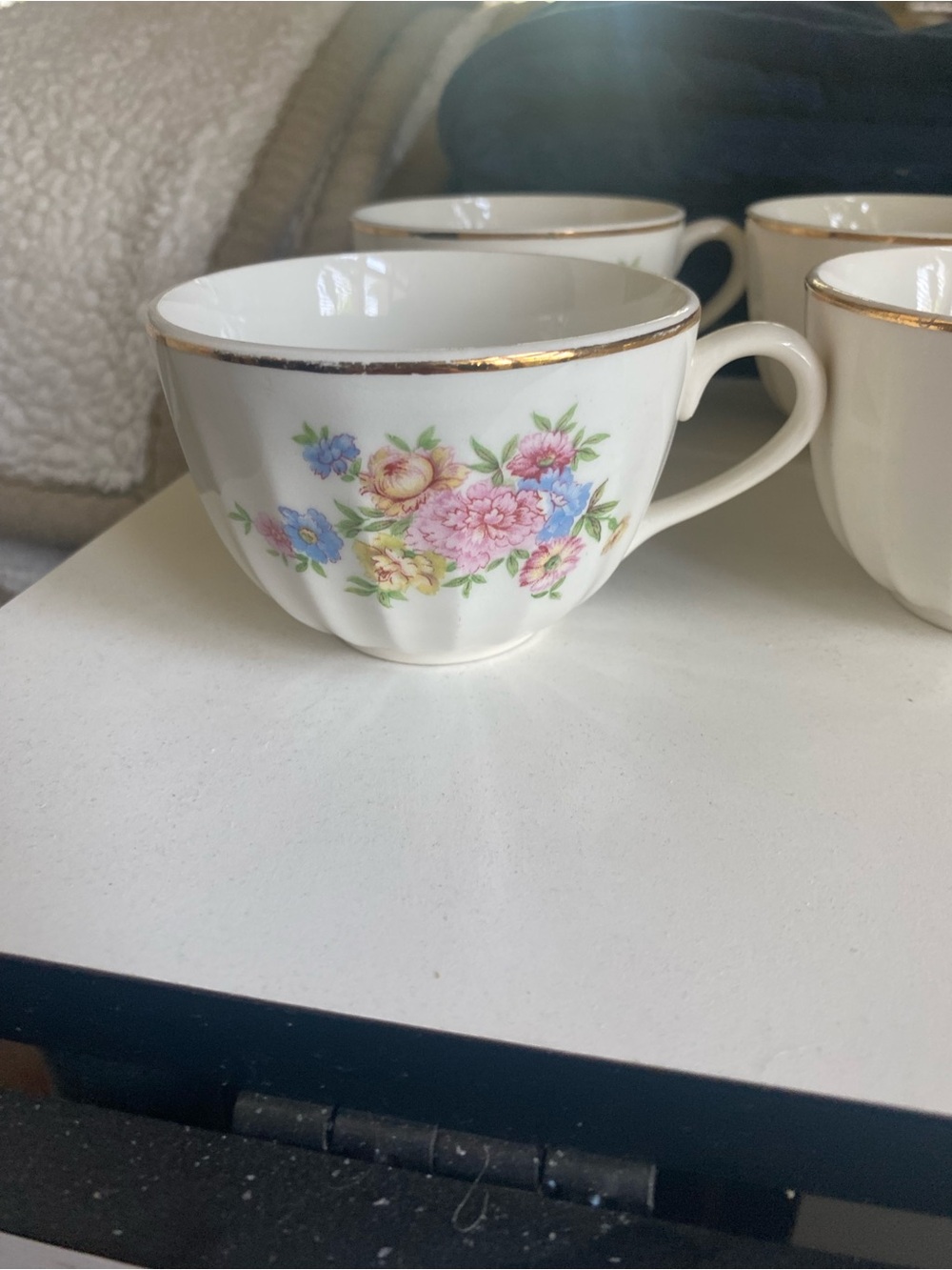 Classic White Porcelain Teacup with Floral Motif and Gold Trim